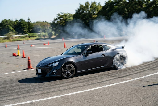 Car driving on an asphalt track during a gymkhana event