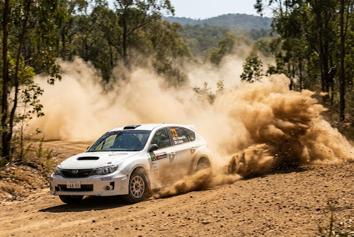 Rally car drifting on dirt track